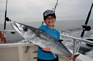 For an outdoor family, fishing creates some of the most memorial times in a child's life. Catching a first fish, a big fish or a certain species forms an unforgettable memory. Combine this with a first camping trip to the beach and it's truly a remarkable vacation. No summer vacation would be complete without a trip to our coast where saltwater opportunities abound. Orange Beach offers a wide variety of species and world-class fishing. And onshore, families can experience a variety of activities and attractions. Plan to spend one of your vacation days with Captain Troy Frady of Orange Beach on his 41-foot Hatteras named Distraction. He offers families highly specialized trips for reef fish on his 41-foot Hatteras named Distraction. He goes the distance to enrich a family’s time on the water. "My focus," Frady explained, "is on people who look at fishing as an experience -- a fun activity while they are on vacation. It's also educational. The deckhand shows the kids how to tie the knots and make the different rigs we fish. Both adults and children are welcome to come upstairs into the wheelhouse to drive the boat and try their hand at navigation by following a GPS course. And whenever we see wildlife, we don't pass it up; you can't assume people have seen dolphins, sea turtles, sharks and the other organisms living in our waters." Frady promotes sustainable fish management by encouraging clients to adopt catch and release or to keep only the best fish. This successful captain also specializes in catching reef fish higher in the water column to avoid injuries from barotrauma. He does not fish on the bottom. "I circle an artificial reef until sonar shows fish suspended over the reef," Frady said. "I hold the boat in position and we start throwing chunks of baitfish to entice them closer to the surface. We usually don't have a problem as red snapper are aggressive feeders." As you can imagine, catching reef fish close to surface has more advantages than the health of the fish: tangles are rare, it is not necessary to vent fish, light tackle is more fun, and the action if faster. Frady's gear for this situation is not what you would expect. "I have bass rods rated for 12-pound-test line," he continued, "but I do use 30-pound-test line due to the sharp teeth on reef fish. However, if the fish are skittish, I'll tie on a 10-pound-test fluorocarbon leader. To take your family fishing with Troy Frady, telephone him at (251) 975-8111 or visit his website at www.distractioncharters.com. An excellent place to stay on Alabama’s coast is the 6,150-acre Gulf State Park located in Gulf Shores. It has two miles of beach, a large campground, cabins, hiking trails and a fishing pier. There is also a golf course, nature center, tennis courts and a 900-acre lake. For more information on Gulf State Park, visit www.alapark.com/parks/gulf-state-park.